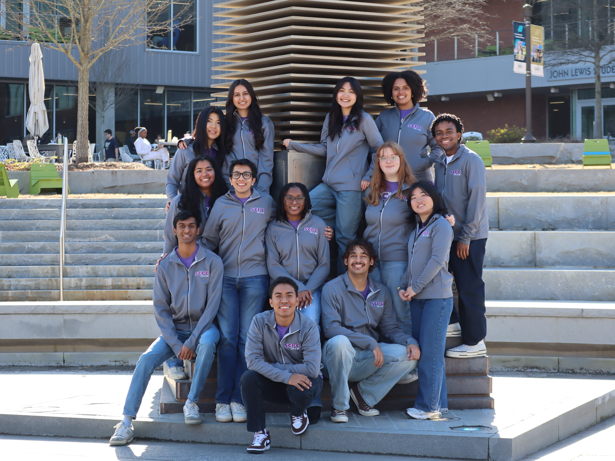 group of students standing in front of campanile