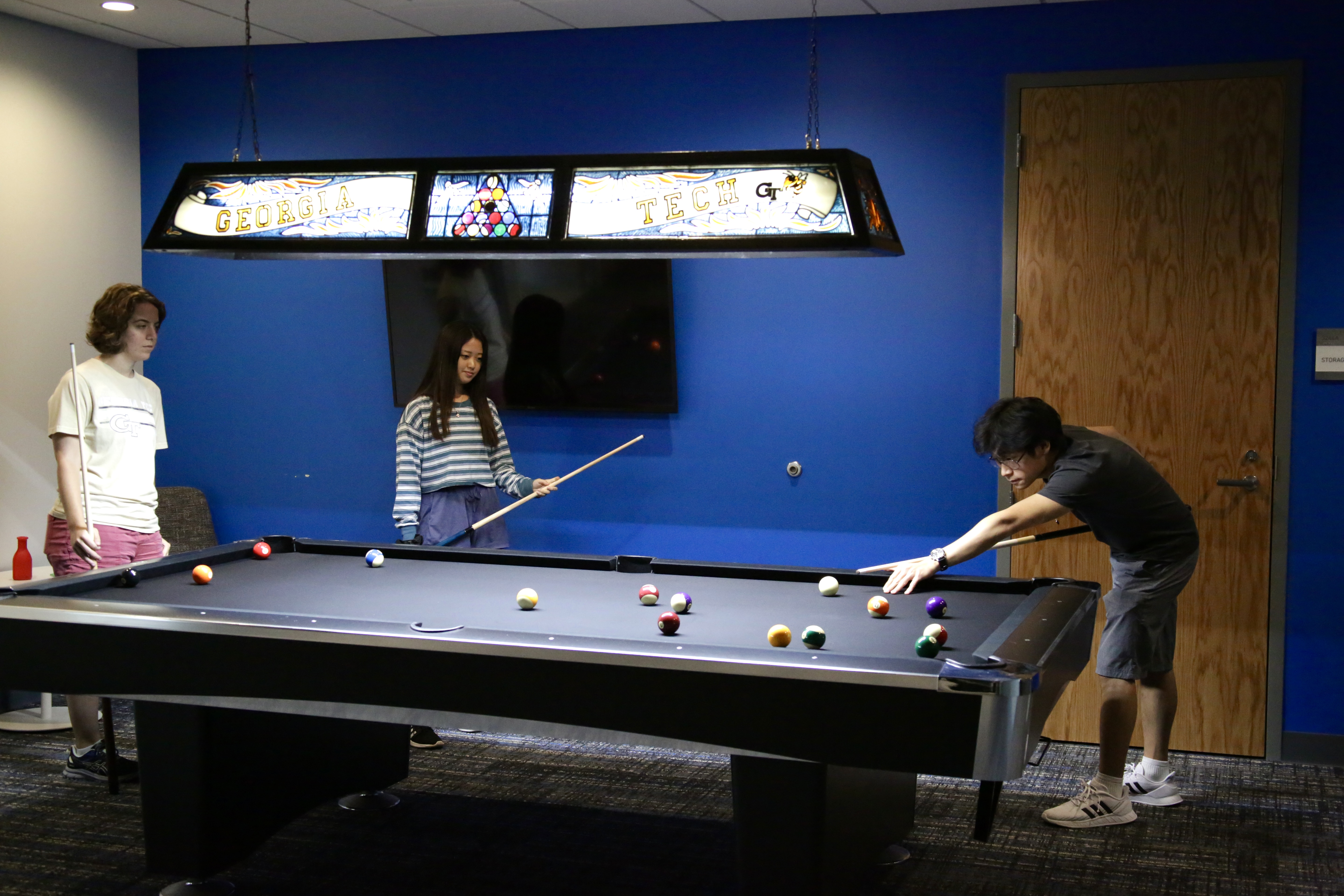 graduate students playing billiards in the lounge